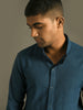 Indigo blue snap button shirt with side pockets and fitted hem