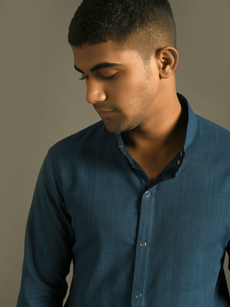 Indigo blue snap button shirt with side pockets and fitted hem